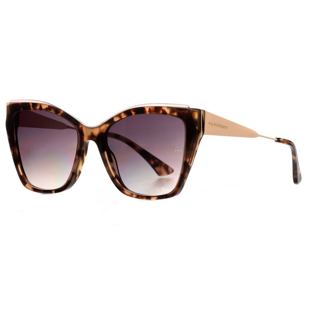 Subtle cat-eye Ana Hickmann sunglass comes in a havana tortoiseshell acetate frame, soft gold metal temples and acetate ends. Brown graduated lenses. Left side view.