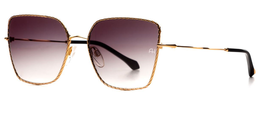 Ana Hickmann butterfly shape sunglass come in a soft gold metal colour with black acetate ends and grey graduated lenses. Left side view.