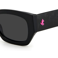 This rectangular Jimmy Choo sunglass features a shiny black with logo print on the arms of the acetate frame and grey lenses. Close up view of JC logo.