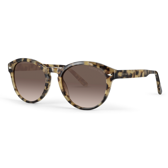 Retro, round eye Cocoa Mint sunglass comes in a light almond tortoiseshell acetate frame with graduated brown lenses.