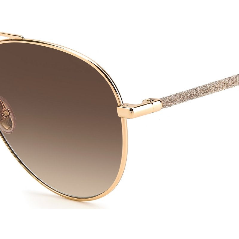 Jimmy Choo Devan Sunglasses features a nude and rose gold metal alloy frame with a brown gradient lens. Glitter embellishment decorates the arms. Close up view.