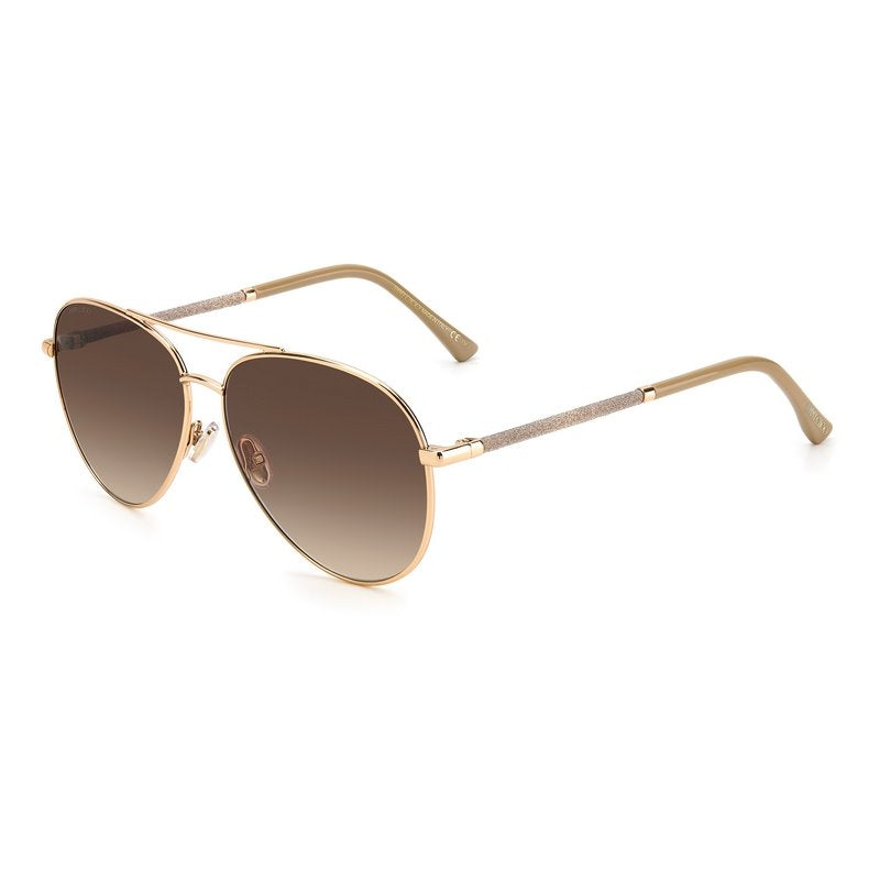 Jimmy Choo Devan Sunglasses features a nude and rose gold metal alloy frame with a brown gradient lens. Glitter embellishment decorates the arms. Left side view.