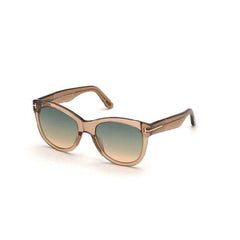 Soft cat-eye acetate style sunglass in a shiny light brown crystal frame with green to brown gradient lenses and a metal 'T' decoration.  Left side view.