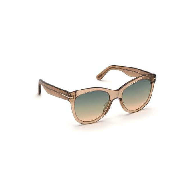Soft cat-eye acetate style sunglass in a shiny light brown crystal frame with green to brown gradient lenses and a metal 'T' decoration. Right side view.