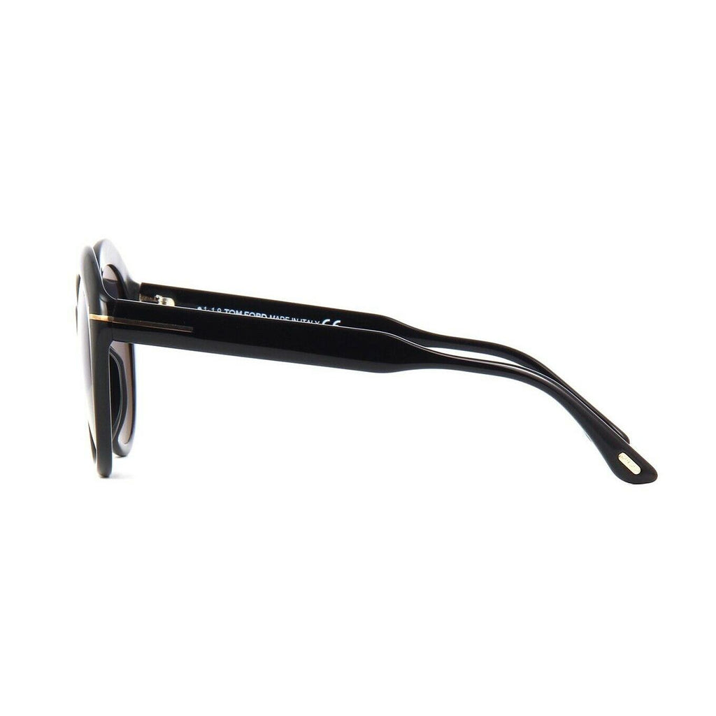 Subtle cat-eye style sunglass comes in a shiny black acetate frame  with a smoked lens.